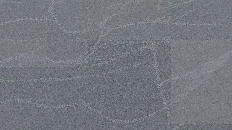 Mottled dark gray quartz countertop with subtle white veining in Gascogne Blue style