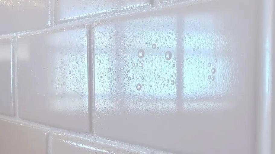 White subway tiles with condensation and reflections on kitchen backsplash