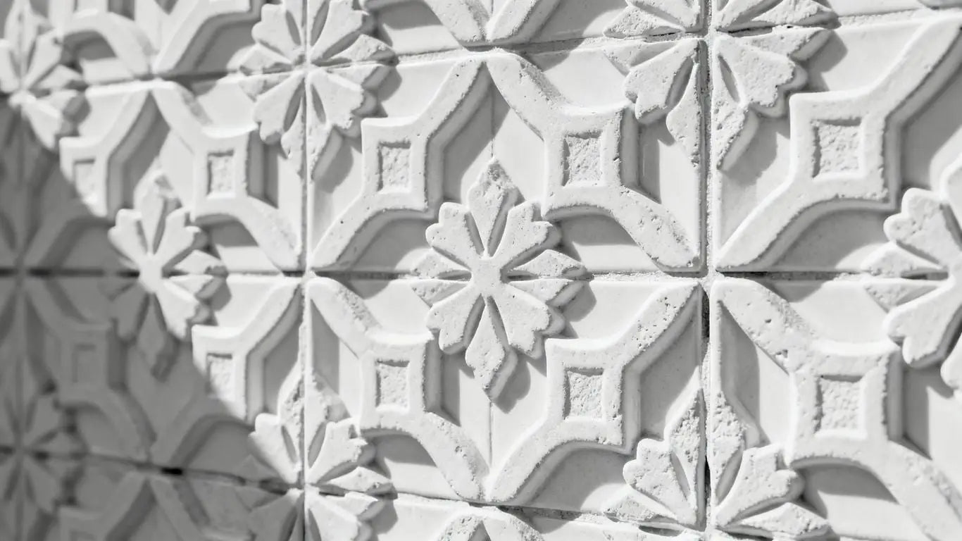 White Arabesque tiles with intricate geometric patterns.