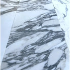 White marble tiles with prominent gray veining in Arabescato Corchia Elite 12X24 Marble Tile