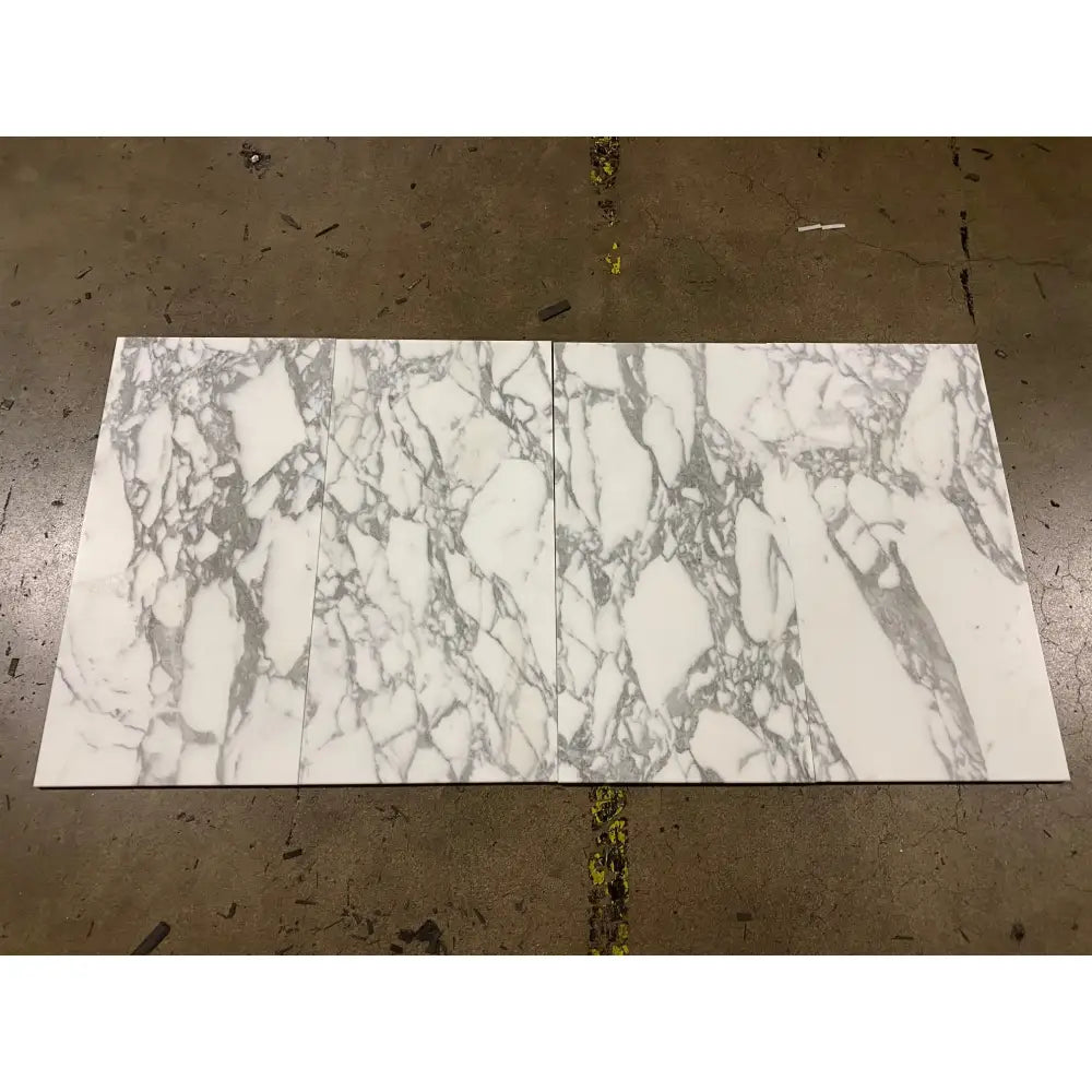 Two rectangular Arabescato Corchia Elite 18X18 marble tiles with grey veining