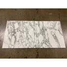 Two rectangular Arabescato Corchia Elite 18X18 marble tiles with gray veining