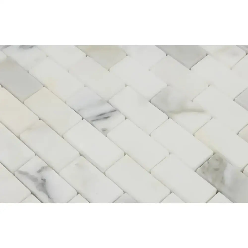 White marble herringbone tile from Calacatta Gold Select 1X2 Brick Mosaic collection