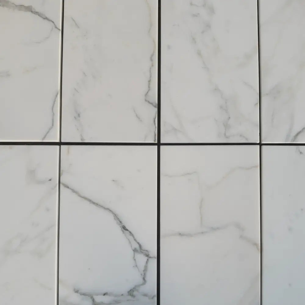 White marble-patterned tiles from Calacatta Gold Select 2x2 Mosaic Marble Tile collection