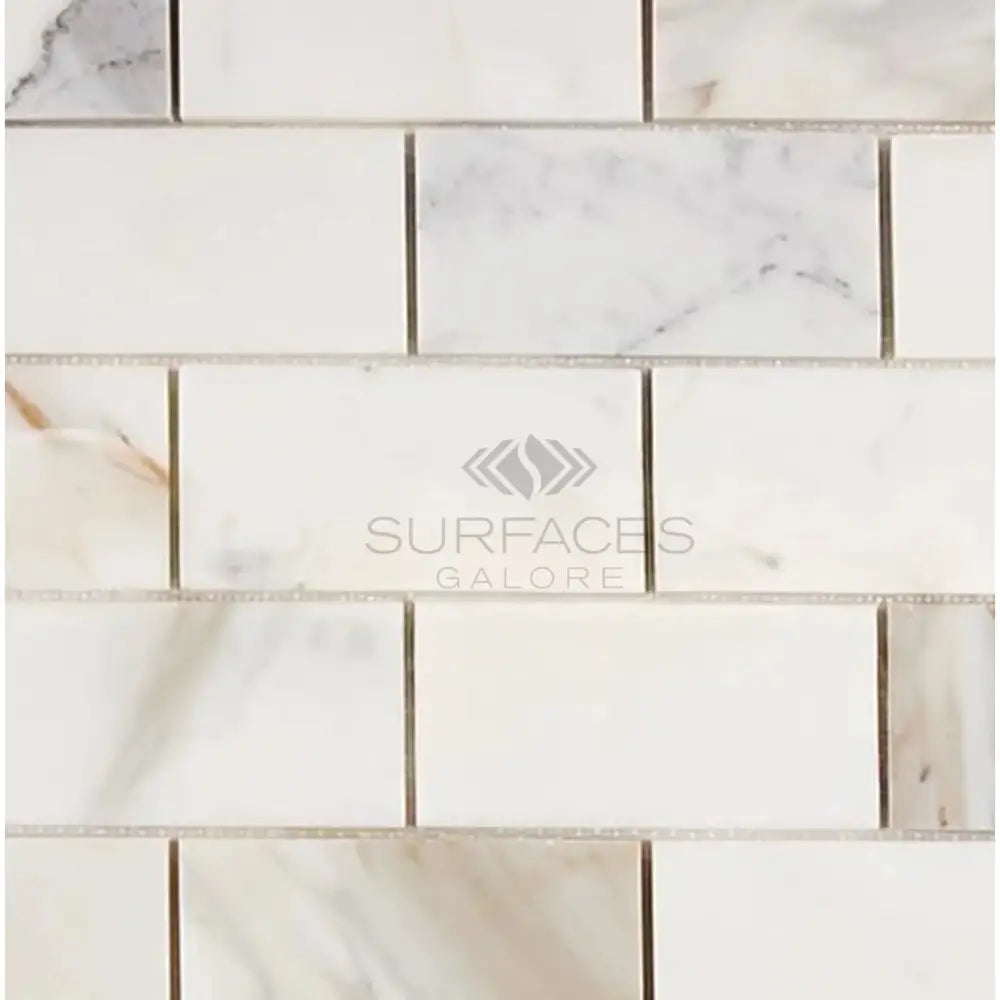 White marble subway tile from Calacatta Gold Select 2X4 Brick Mosaic collection