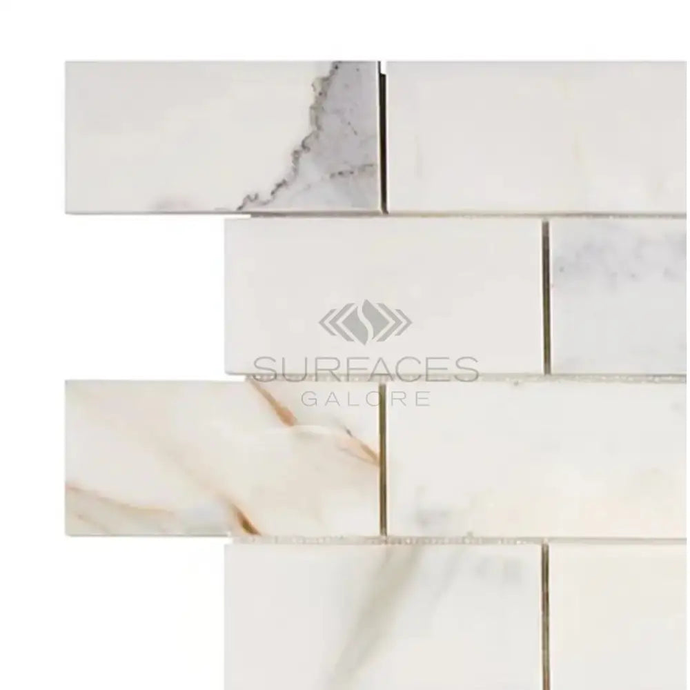 Marble-patterned subway tile from Calacatta Gold Select 2X4 Brick Mosaic collection