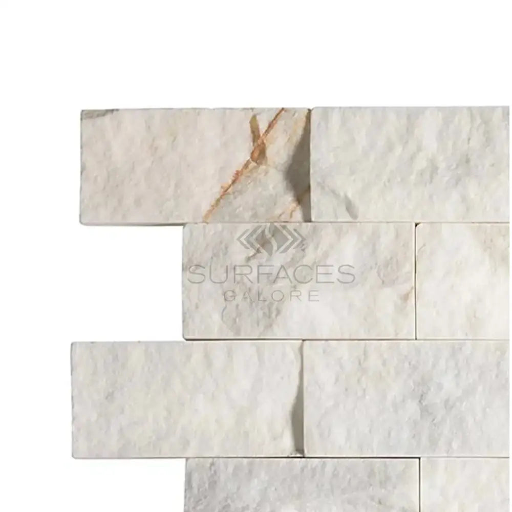 Stacked white marble tiles from Calacatta Gold Select 2X4 Brick Split-Faced Mosaic