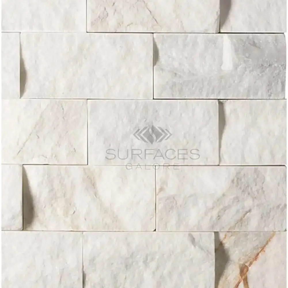 White marble stacked stone featuring Calacatta Gold Select Gold Mosaic Tile