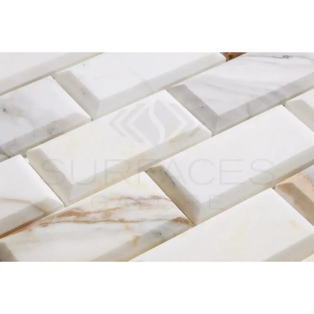 Rectangular Calacatta Gold Select Marble Tiles in 2x4 deep-beveled brick mosaic pattern