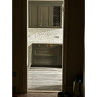Gray kitchen cabinets with Calacatta Gold Select Gold 4 3/4X12 baseboard trim