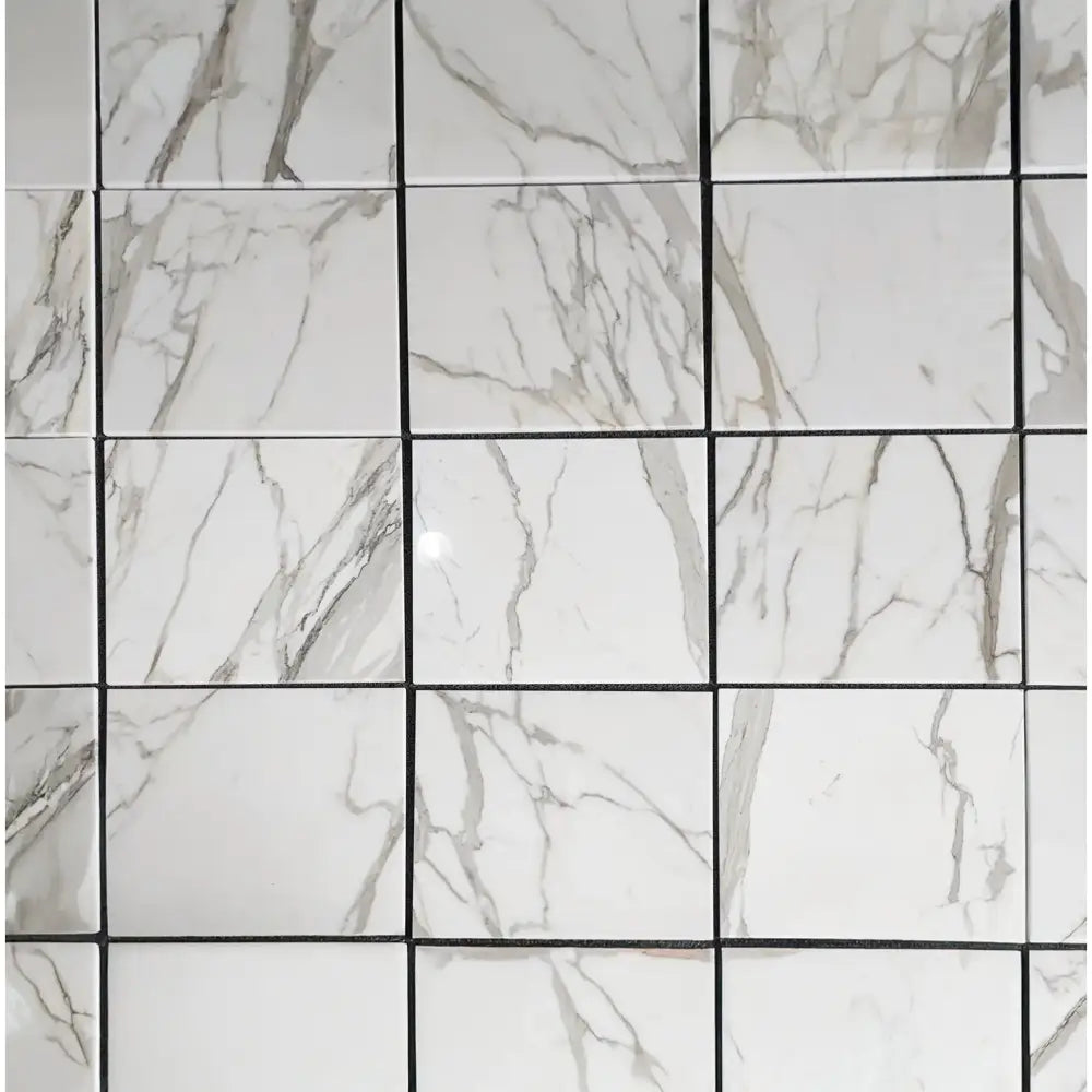 White marble-patterned tile grid for Calacatta Gold Select Gold 4 3/4X12 baseboard trim