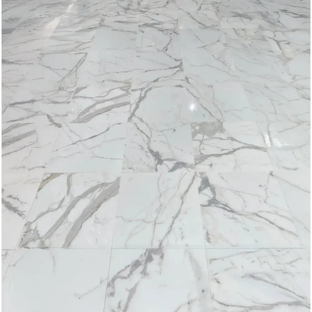 White marble tile flooring featuring Calacatta Gold Select mosaic with polished or honed finish
