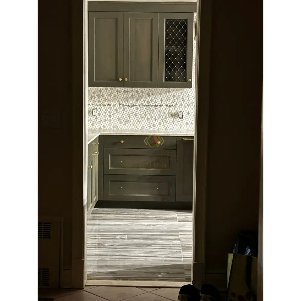 Olive green kitchen cabinetry paired with Calacatta Gold Select Mosaic Marble Tile