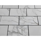 White Calacatta Gold marble tiles with dark grout for elegant flooring or walls