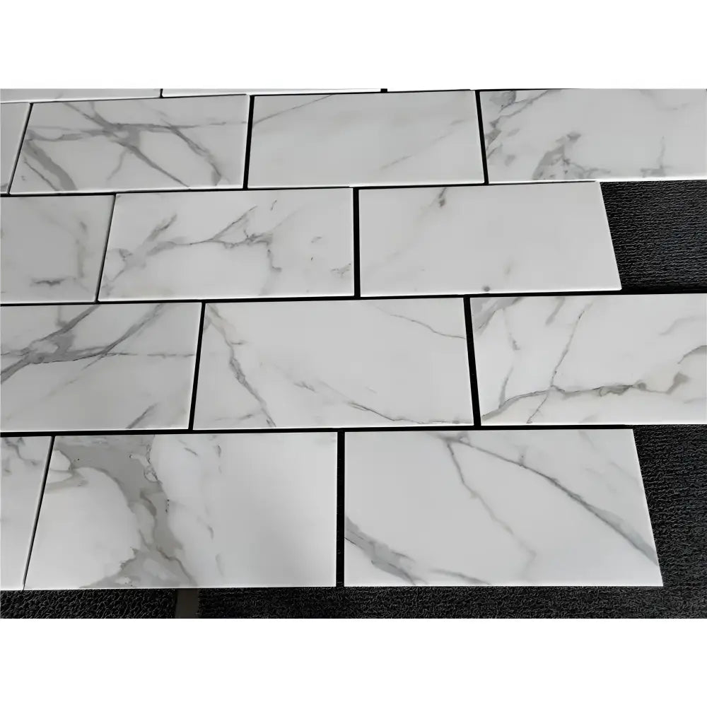 White marble-patterned rectangular tiles from Calacatta Gold Select in 12x24 polished or honed options