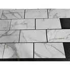 White marble-patterned rectangular tiles from Calacatta Gold Select in 12x24 polished or honed options