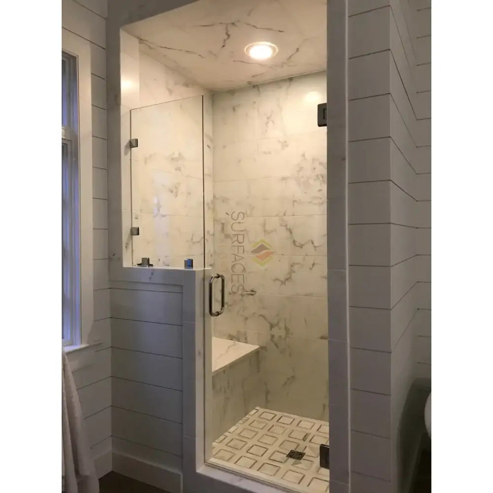 Modern marble shower stall featuring Calacatta Gold Select Gold Marble 18x18 tiles