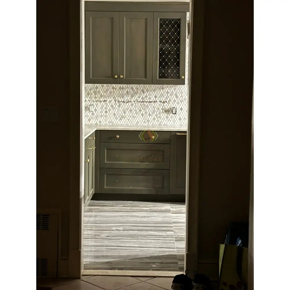 Olive green kitchen cabinets with Calacatta Gold Select Gold Marble 18x18 tiles