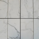 White marble-patterned tiles from Calacatta Gold Select Gold Marble 24x24 collection