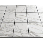 White marble-patterned tile floor from Calacatta Gold Select Gold Marble 24X24 collection