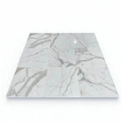 Marble-patterned floor tiles from Calacatta Gold Select Gold Marble 2X8 collection