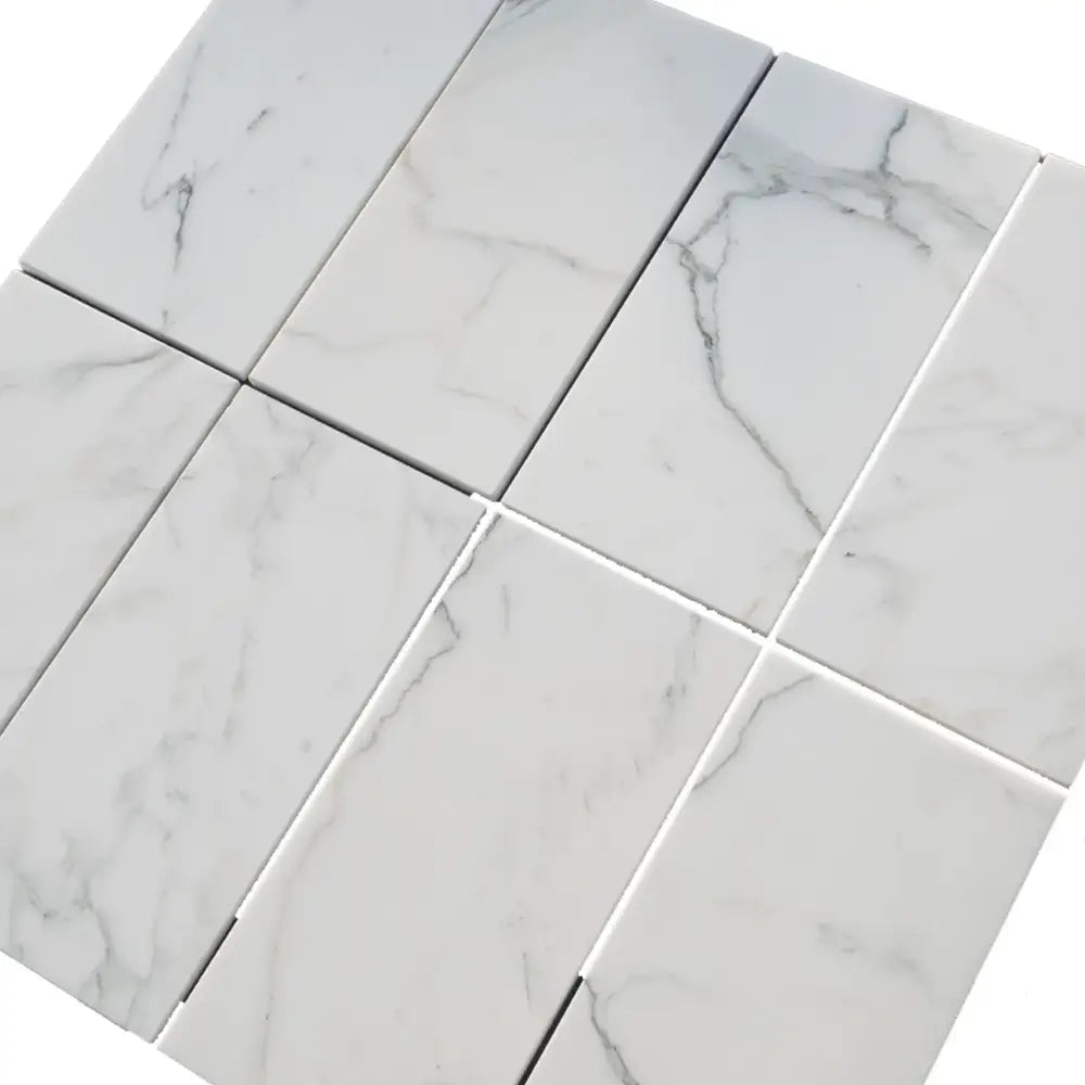 White marble tile arrangement of Calacatta Gold Select Gold Marble 4X12 polished or honed