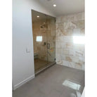 Glass-enclosed shower with Calacatta Gold Select Gold Marble 4x12 tiles