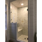 Modern glass shower enclosure with Calacatta Gold Select Gold Marble tiles