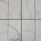 White marble-patterned tiles from Calacatta Gold Select Gold Marble collection