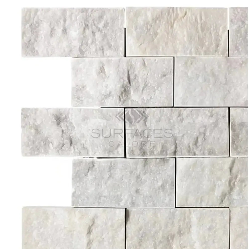 Carrara White Royale White Royale 2X4 Brick Mosaic Marble Tile on a white stone brick wall