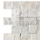 Carrara White Royale White Royale 2X4 Brick Mosaic Marble Tile on a white stone brick wall