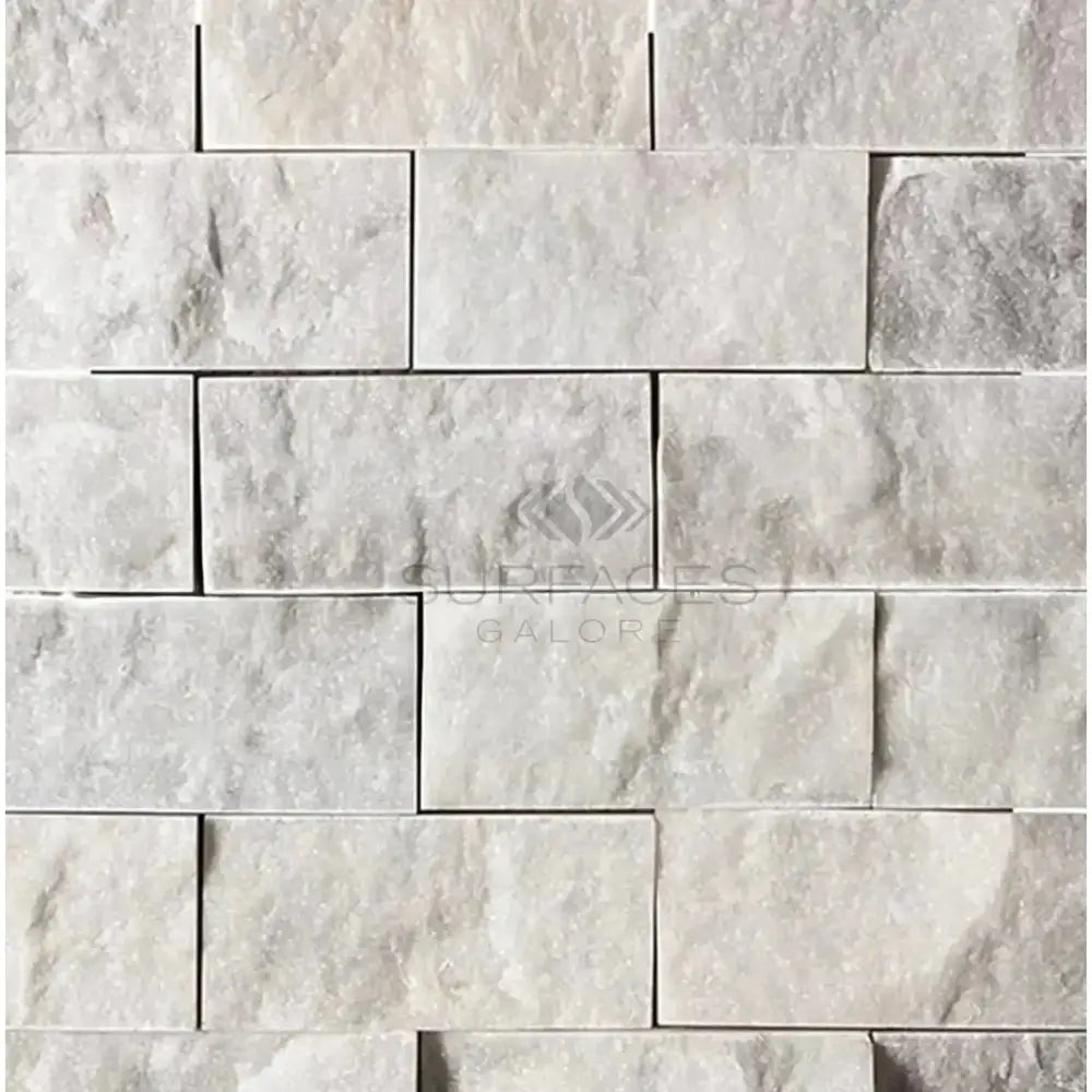 White stone brick wall featuring Carrara White Royale 2x4 Mosaic Marble Tile