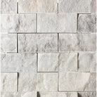 White stone brick wall featuring Carrara White Royale 2x4 Mosaic Marble Tile