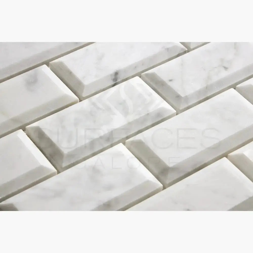 White marble beveled subway tiles from Carrara White Royale 2X4 mosaic collection