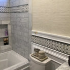 Bathroom interior with Carrara White Royale marble tile and decorative brick mosaic