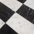 Black and white marble tile pattern from Carrara White Royale and Nero Marquina Prestige set