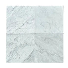 Four Carrara White Royale marble tiles 12x12 Tumbled displayed for product listing