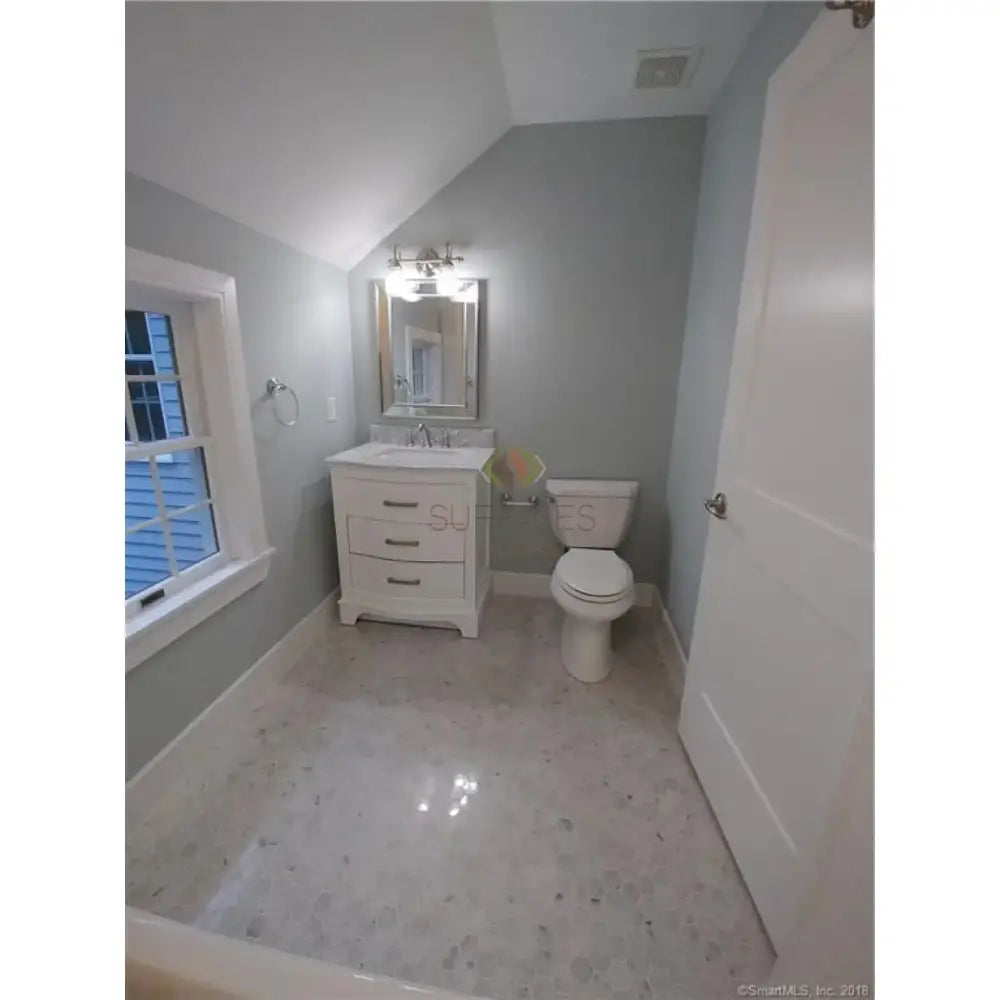 Bathroom with white fixtures featuring Carrara White Royale Marble 3X6 Tumbled tiles