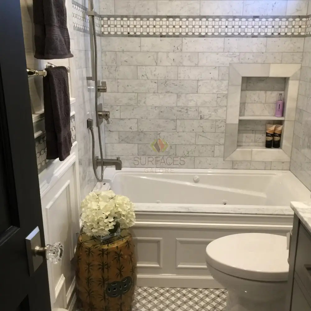 Bathroom with Carrara White Royale Marble 3X6 Tumbled Tile on walls