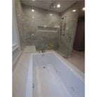 White bathtub with jets featuring Carrara White Royale Marble 3X6 Tumbled surface