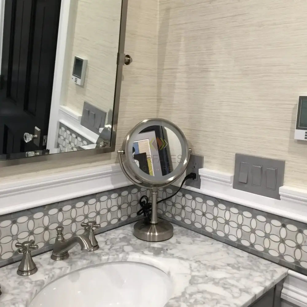 Illuminated vanity mirror with Carrara White Royale Marble 3x6 Tumbled surround