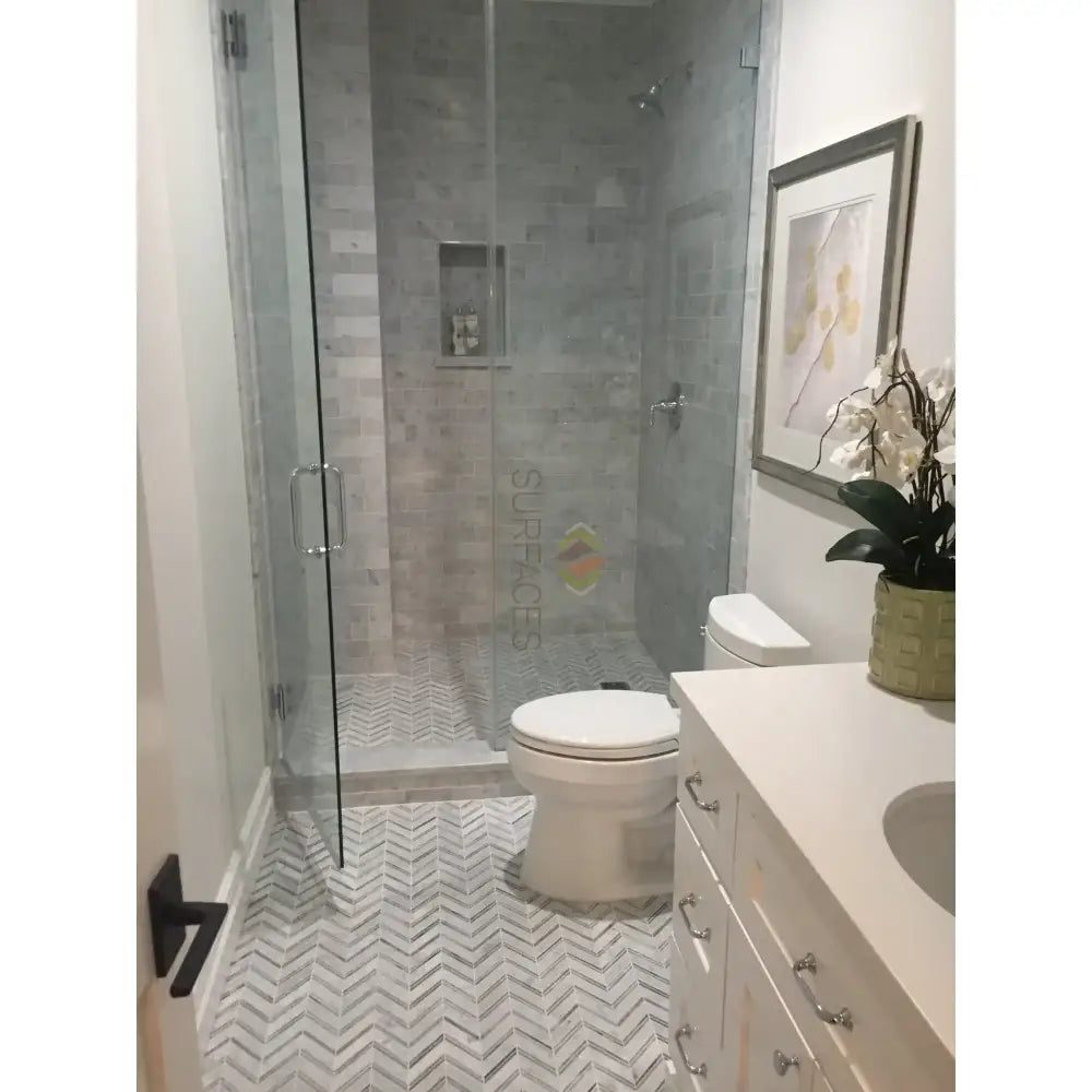Modern bathroom interior featuring Carrara White Royale Marble 3x6 Tumbled tiles