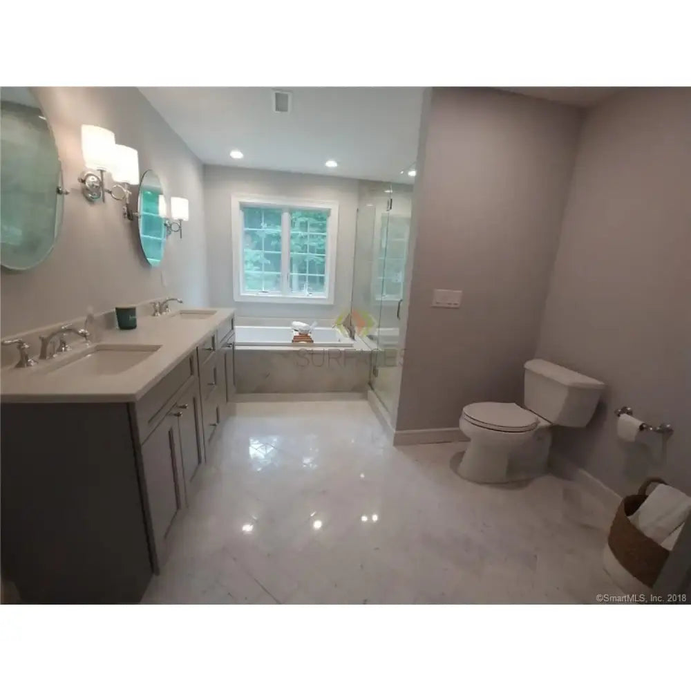 Modern bathroom interior featuring Carrara White Royale Marble 3X6 Tumbled tiles