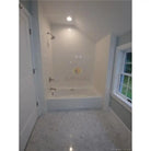 White tiled bathtub with Carrara White Royale Marble 3x6 tumbled tiles