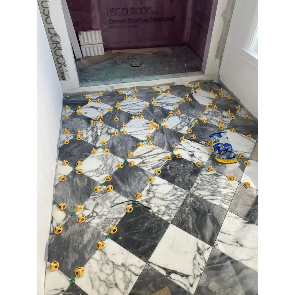 Marble tile floor installation with Checkerboard Bardiglio Prime and Rojo Alicante Select 12X12 Set