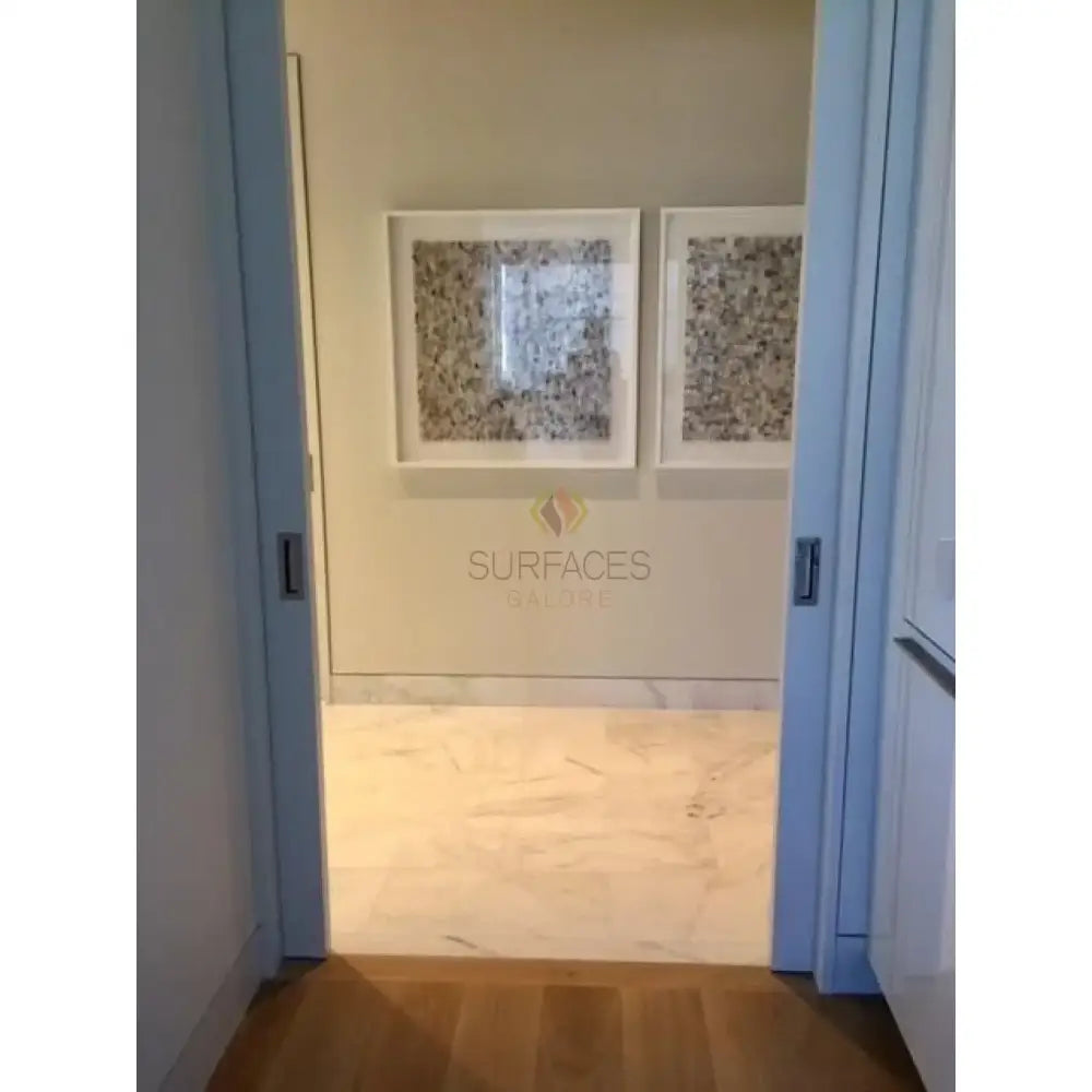 Hallway with marble flooring and framed artwork showcasing Checkerboard Bardiglio Prime and Aurora White Marbles