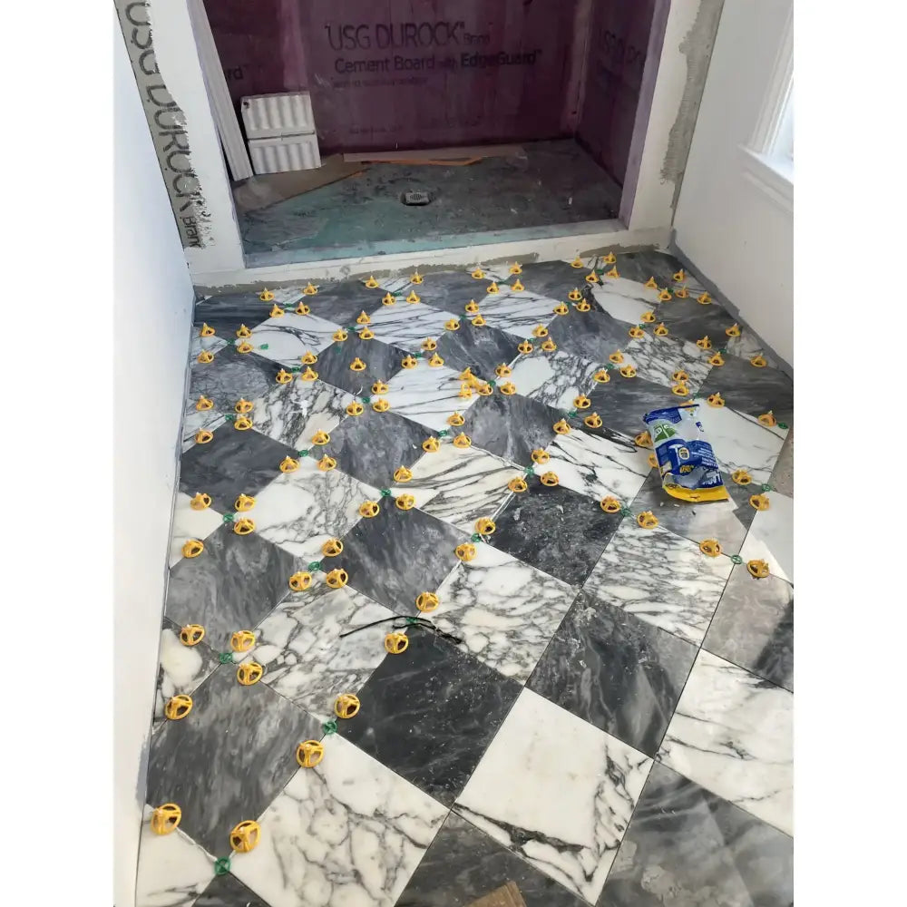 Marble tile floor installation featuring Checkerboard Bardiglio Prime and Aurora White Marble