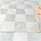 Checkerboard marble floor featuring Carrara White Royale and Oriental White Aurora tiles