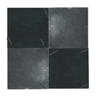 Four dark square tiles from Checkerboard Crema Marfil Select and Emperador Dark Oro Tumbled Set