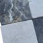 Four square stone tiles from Checkerboard Crema Marfil Select and Emperador Dark Oro Tumbled Set